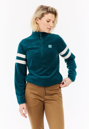 Teal fleece pullover med en halv-zipkrave, hvide striber på ærmerne og et firkantet logo på brystet. Blød tekstur og tætsiddende design.