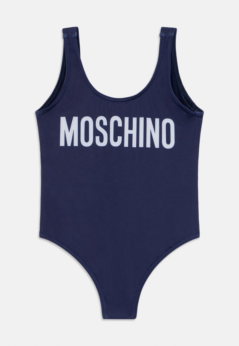 Navy blue one-piece swimsuit with a rounded neckline and wide straps. Features white "MOSCHINO" text across the chest. Smooth fabric texture.