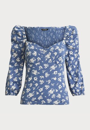 Blue floral blouse with puff sleeves, square neckline, and smocked detail. Features a white flower pattern on soft fabric.