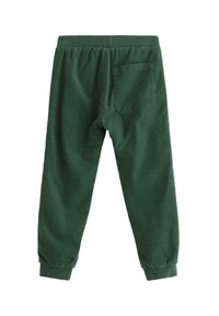 Gröna mjuka joggers i avslappnad passform, med elastisk midja och ribbade vristhål. Har en enda bakficka.