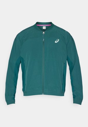 Τζάκετ σε πετρόλ χρώμα με πλήρες φερμουάρ και γιακά που σηκώνεται. Διαθέτει διάτρητο σχέδιο στους ώμους, ελαστικά μανίκια και λογότυπο στο πάνω αριστερό μέρος του στήθους.