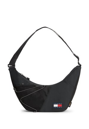 Czarna torebka na ramię z regulowanym paskiem, przednia kieszeń z siateczki z sznurkiem oraz logo Tommy Jeans w dolnym przednim rogu.