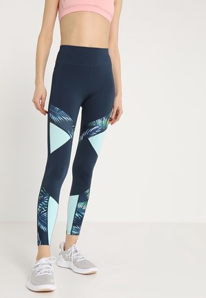 Leggings marine avec des panneaux géométriques en menthe et des motifs de feuilles tropicales. Design taille haute, fabriqué à partir d'un tissu extensible et respirant.