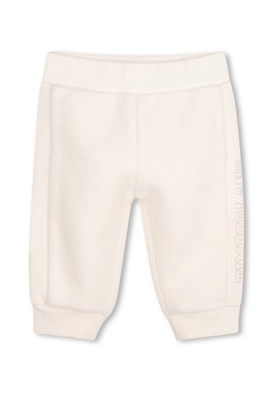 Pantalon bébé doux couleur crème avec taille et poignets côtelés, avec un texte embossé discret sur le côté de la jambe.