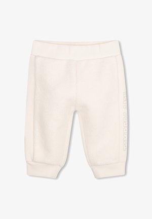 Pantalon bébé doux couleur crème avec taille et poignets côtelés, avec un texte embossé discret sur le côté de la jambe.
