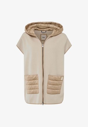 Beige hoodie poncho met een rits aan de voorkant, met gequilte pocketdetails en een zachte textuur. De zakken hebben gestikte patronen voor extra detail.