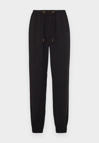 Black sweatpants made of soft fabric, featuring an elastic waistband with drawstring and elastic cuffs. Smooth texture without patterns.