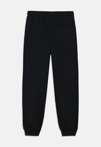 Svarte joggebukser laget av en blanding av bomull, med elastisk midjebånd, manchetter ved anklene og en enkelt baklomme.