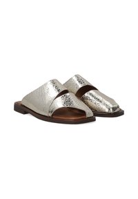 Metallic silver open-toe slide sandals with two wide straps and a flat brown sole, featuring a textured finish for added visual interest.