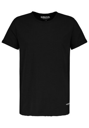 Black crew neck short-sleeve T-shirt with rolled cuffs, small "Urban" tag at hem, and "Sublevel" brand label inside collar.
