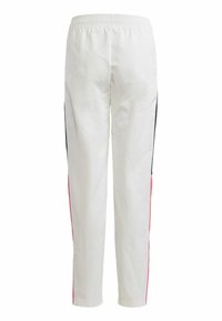 Witte broek met een elastische tailleband, voorzien van verticale zijstrepen in zwart en roze. Soepele textuur en taps toelopende broekspijpen.