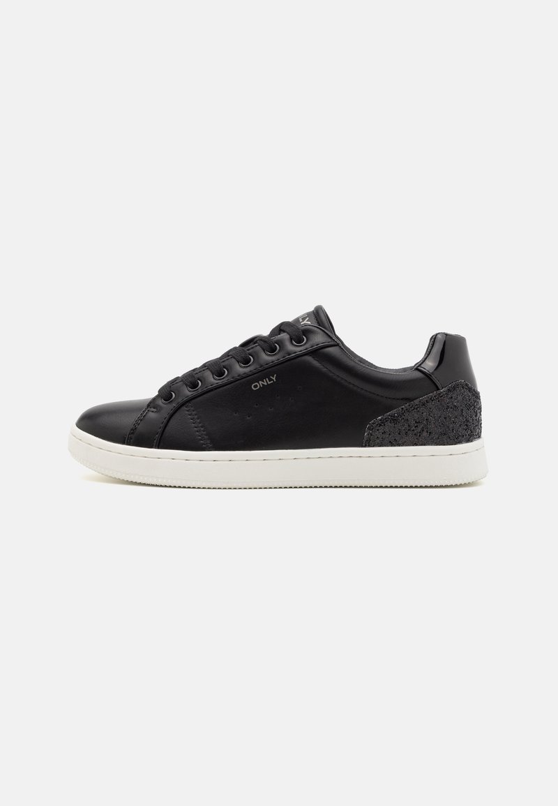 Zapatillas de cuero negro con suela de goma blanca, punta redondeada y acento texturizado negro en el talón. Cuentan con cordones y seis ojales.