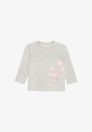 Lichtgrijs langslavige babyshirt met roze 3D bloemenapplicaties en geborduurde stelen en bladeren aan de rechtervoorzijde.