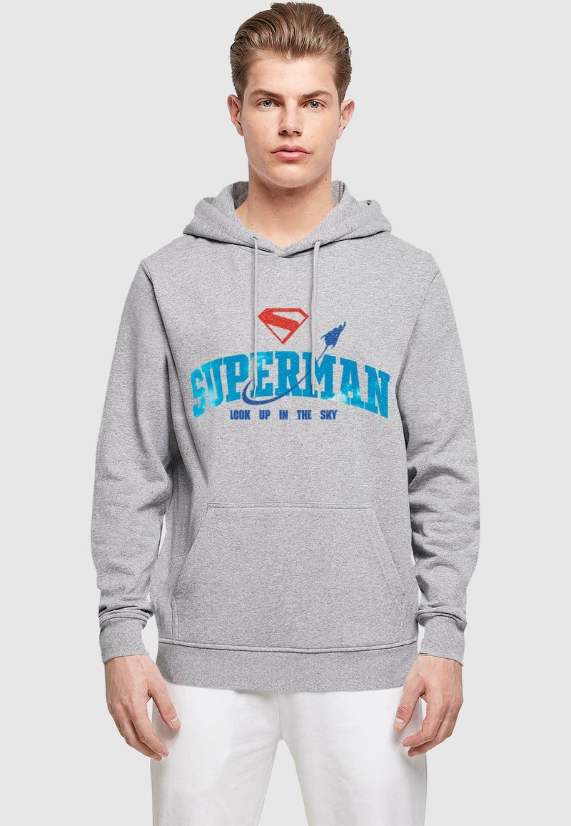 Gray hoodie with a front pocket. Features a red Superman logo and blue text reading "SUPERMAN LOOK UP IN THE SKY." Made of cotton blend.
