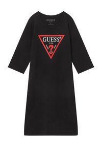 Musta pitkähihainen mekko, jossa on punainen kolmion muotoinen logo rinnan kohdalla, jossa lukee "GUESS U.S.A." ja punainen kysymysmerkki sisällä.