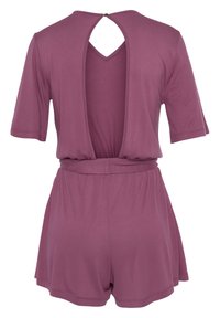 Raspberry-colored romper with short sleeves, open back, and elastic waist. Made from soft fabric with a relaxed fit and rounded hemline.