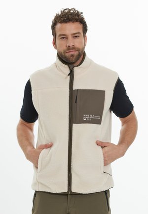 Gilet en polaire de couleur crème avec une poche sur la poitrine marron, fermeture éclair et deux poches avant. Le texte sur la poche indique "WHSTLR Outdoor."