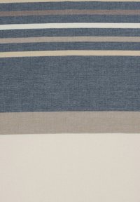 Striped fabric featuring dark navy, light beige, and cream stripes with varying widths, textured weave, and a smooth finish at the bottom.