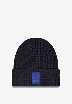 Navy knitted beanie with a ribbed texture, folded cuff, and a rectangular blue patch featuring the Buffalo Bills logo and text.