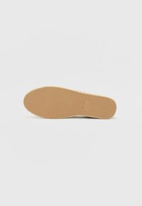 Tan rubber shoe sole with ribbed texture, rounded shape, and slight tapering at the toe. Simple design, no visible branding or accents.