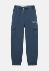 Calças jogger em mistura de algodão azul-marinho com cintura elástica, cordão bege, bolsos laterais tipo cargo e logótipo "LEVI'S" em bege na coxa.