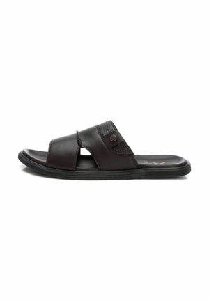 Sandalia slide de cuero marrón con una correa ancha, punta abierta y acentos texturizados. Presenta una suela exterior de goma negra duradera.
