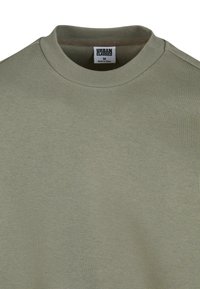 Olivengrøn sweatshirt med rund hals og ribbet krave. Fremstillet af blødt materiale, med en struktureret finish og et mærke i kraven.