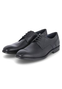 Schwarze Schnürschuhe aus glattem, durchbrochenem Leder mit abgerundeter Zehenpartie und einem flachen Gummisohle. Minimalistisches Design mit dezenten Nähten.