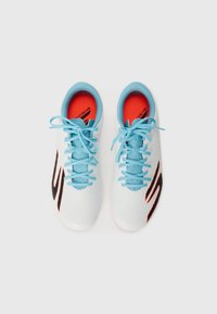White athletic shoes with a textured surface, blue laces and accents, and orange inner lining. Features a distinctive black logo on the side.