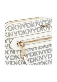Portafoglio bianco con zip, logo DKNY e motivo di testo ripetuto. Dotato di hardware color oro e texture liscia.