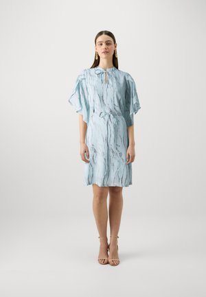 Light blue short dress with a keyhole neckline, flutter sleeves, and a tie belt, featuring a wavy silver pattern. Smooth fabric texture.