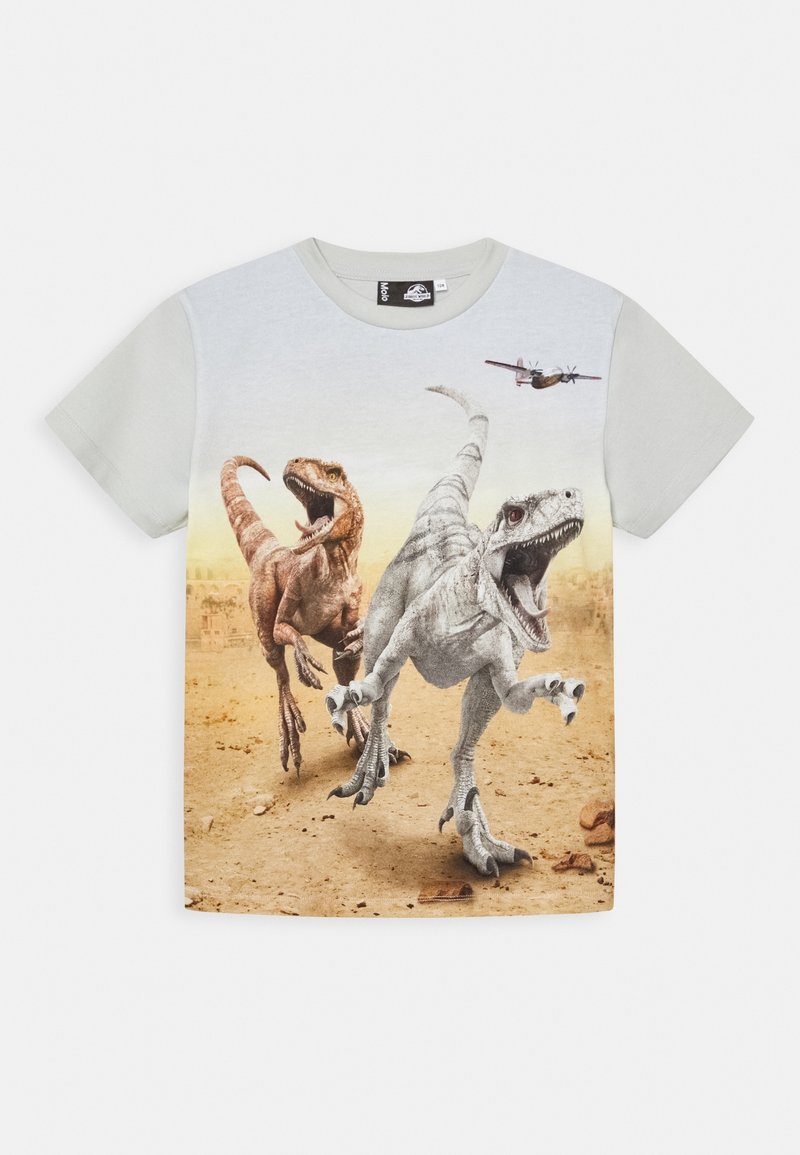 Chemise à manches courtes avec deux dinosaures courant et un avion volant sur un fond désertique.