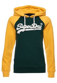 Felpa verde e gialla con cappuccio regolabile, grande tasca frontale e logo "SuperDry" bianco sul petto. Tessuto morbido.