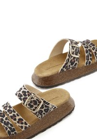 Leopard print sandals feature three patterned straps with a metal buckle. The footbed is cork with a textured brown sole for grip.