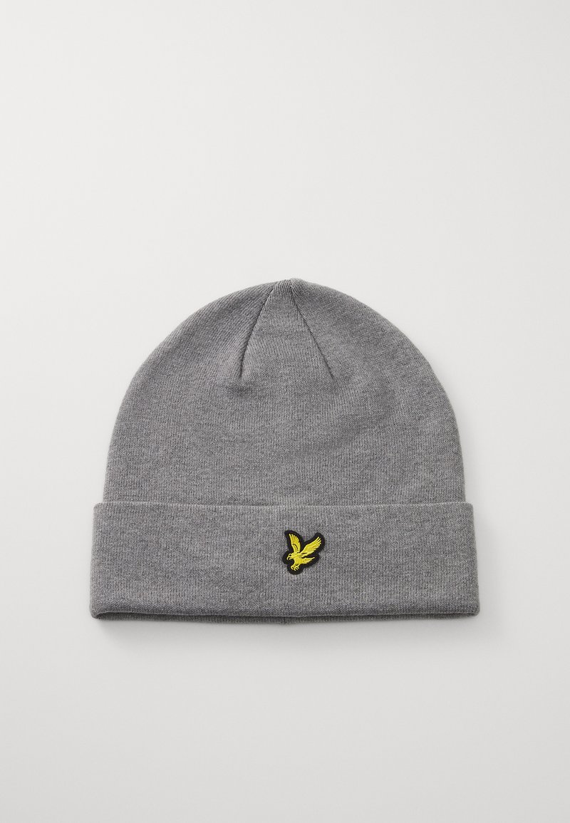 Bonnet en tricot gris avec un ourlet replié, présentant un logo d'oiseau brodé noir et jaune à l'avant. Texture douce et forme épurée.