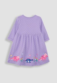 Fialové šaty s dlhým rukávom a bielymi bodkami. Na leme sú vyšívané dinosaury a kvety. Vyrobené z mäkkej tkaniny, s rozšíreným strihom.
