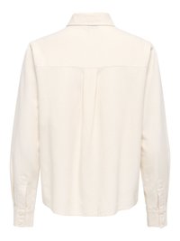 Chemise à manches longues blanc cassé vue de dos avec un pli central et des poignets boutonnés.