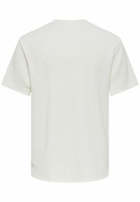 T-shirt blanc uni texturé à manches courtes, vu de dos, avec un col rond et une coupe régulière.