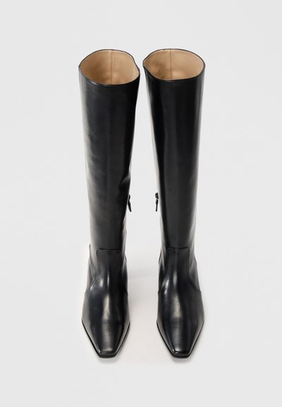 Black leather thigh-high boots with a smooth texture, pointed toes, side zippers, and an inner lining in a lighter color.