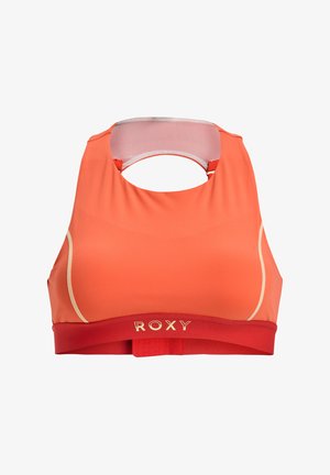 Sport-BH in leuchtendem Orange, mit Rundhalsausschnitt und offener Rückseite. Goldenen Logo auf rotem Bund. Glattes, elastisches Material.