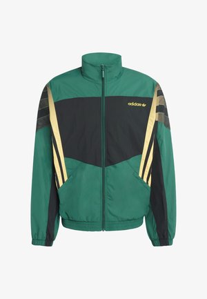 Zelená a čierna bunda so zlatými detailmi, s vysokým golierom, zapínaním na zips a bočnými vreckami. Vyrobená z ľahkého, textúrovaného materiálu.