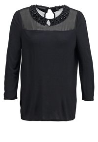Top a maniche lunghe nera con scollatura trasparente e colletto decorato con perline, chiusura a oblò sul retro e spacchi laterali per facilitare il movimento.