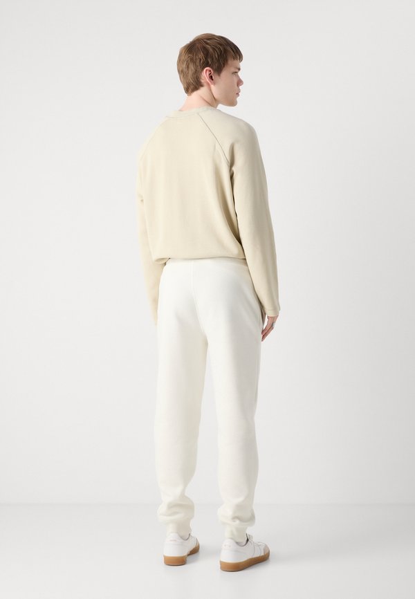 MONOLOGO - Tracksuit bottoms - ivory3