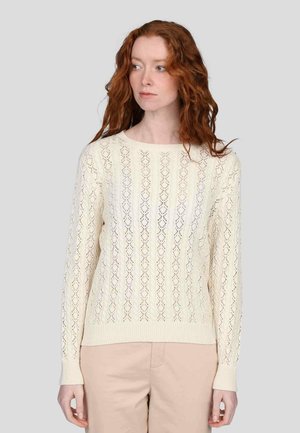 Pull en tricot couleur crème avec un motif en diamant, manches longues et poignets côtelés. Tissu léger et texturé avec une coupe décontractée.