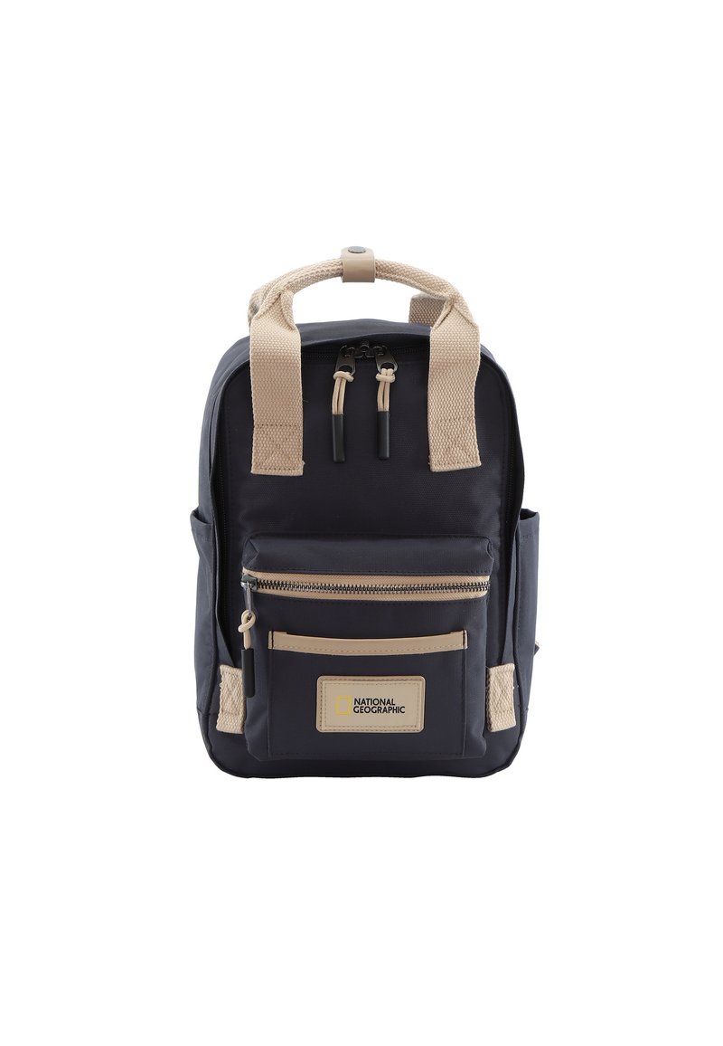 Navy backpack with beige straps and accents. Features a front zip pocket, logo patch, and textured fabric. Compact design and sturdy construction.