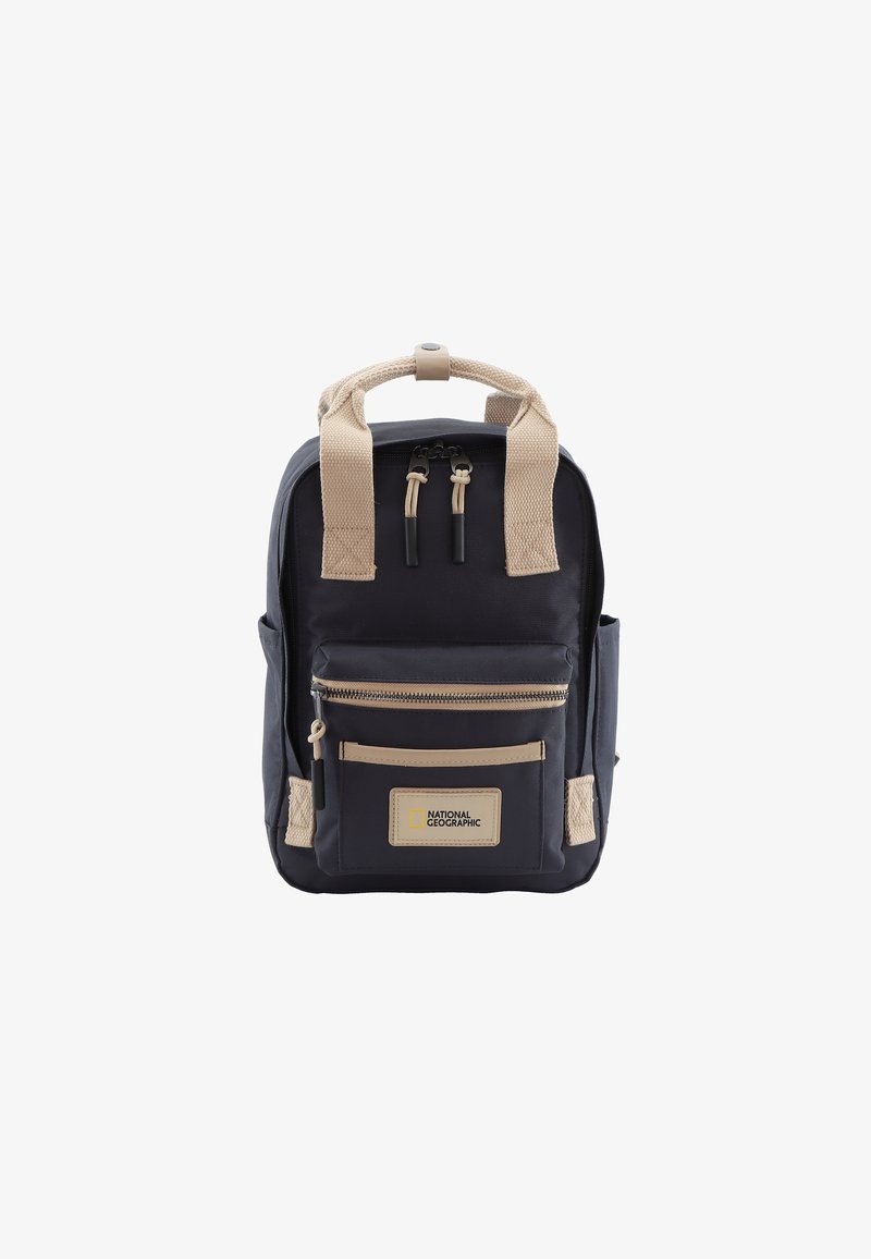 Navy backpack with beige straps and accents. Features a front zip pocket, logo patch, and textured fabric. Compact design and sturdy construction.