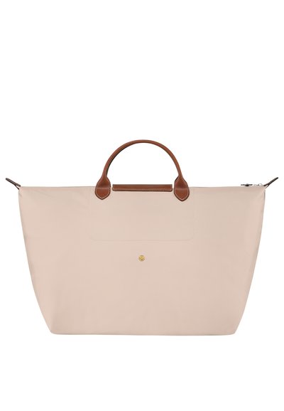 Beige tote bag made of soft fabric, featuring brown leather handles and accents, a flat design, and a subtle gold logo detail on the front.