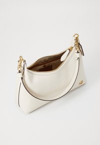 White leather handbag with gold hardware, zip closure, and a contrasting dark trim. Features a single shoulder strap and interior pocket.