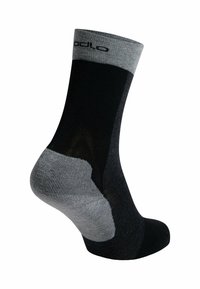 Schwarze und graue Socke mit geripptem Bündchen, verstärktem Fersen- und Zehenbereich. Sie besitzt eine glatte Textur und ein eingesticktes Logo an der Spitze.