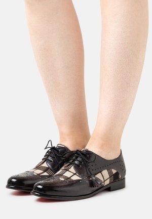 Black patent leather shoes with a checkered textile upper, lace closure, and decorative perforations on the sides and toe. Flat sole.